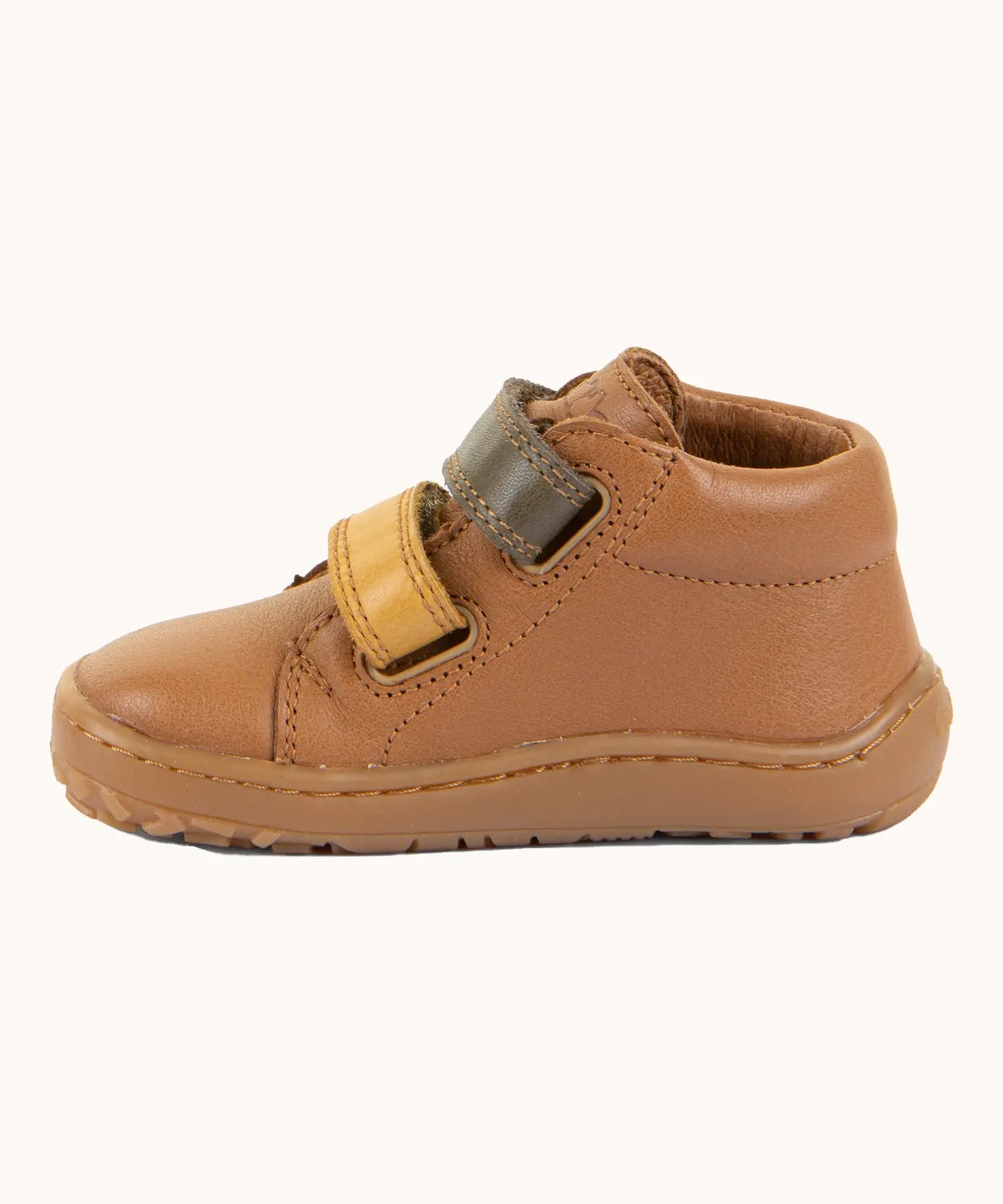 Side of Froddo light brown natural leather barefoot first step kids shoes showing the padded ankle support. Boot has a flexible rubber sole zero-drop profile