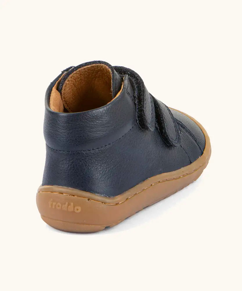 Back of the Froddo barefoot first step baby shoe in dark blue showing a padded ankle support and grippy sole 