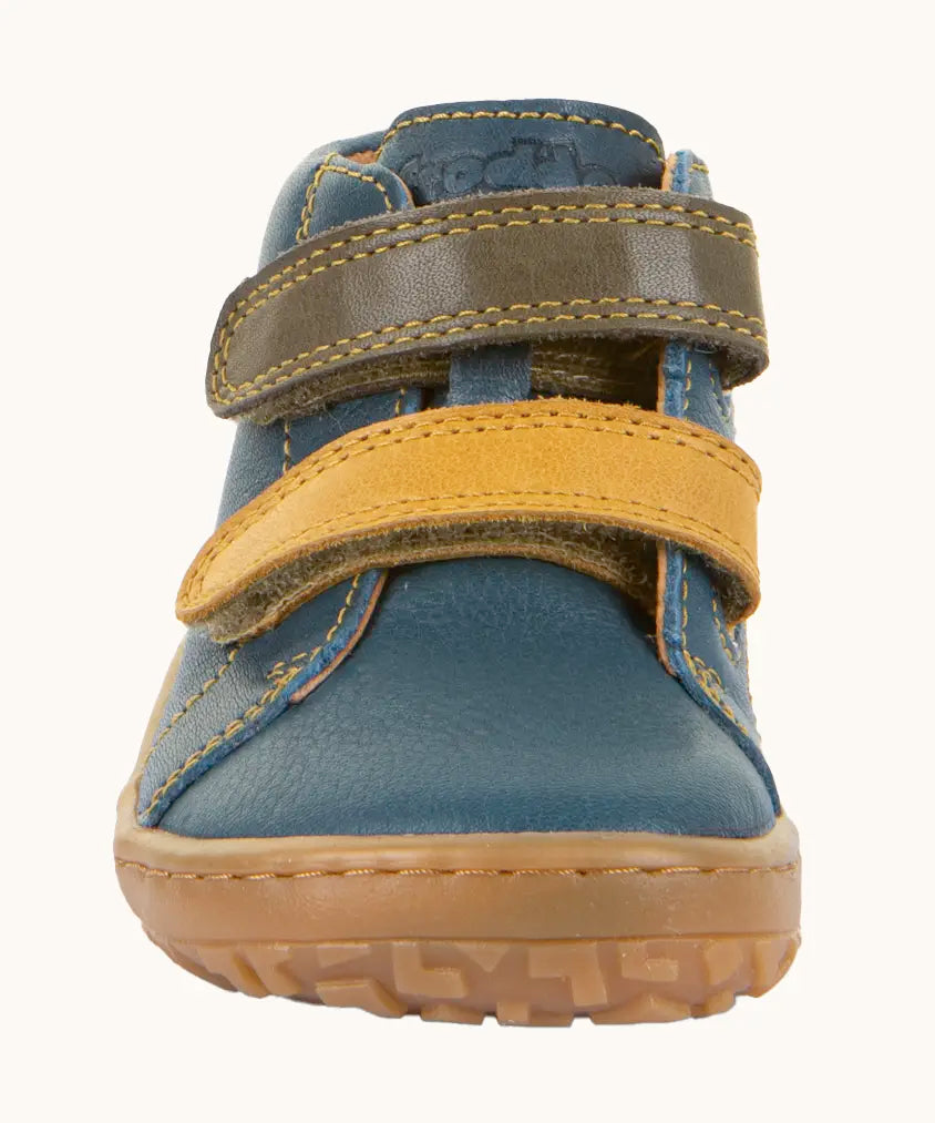 Front of Froddo's denim blue natural leather barefoot first step kids shoes showing the olive and mustard straps. Boot has a wide toe box shape