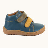 Side of Froddo's light brown natural leather barefoot first step kids shoes showing the velcro straps fastened. Boot has a flexible rubber sole zero-drop profile