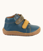 Side of Froddo's light brown natural leather barefoot first step kids shoes showing the velcro straps fastened. Boot has a flexible rubber sole zero-drop profile