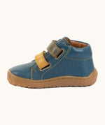 Side of Froddo's denim blue natural leather barefoot first step kids shoes showing the padded ankle support. Boot has a flexible rubber sole zero-drop profile