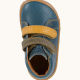 Top view of Froddo's denim blue natural leather barefoot first step kids shoes showing the olive and mustard straps. Boot has a wide toe box shape