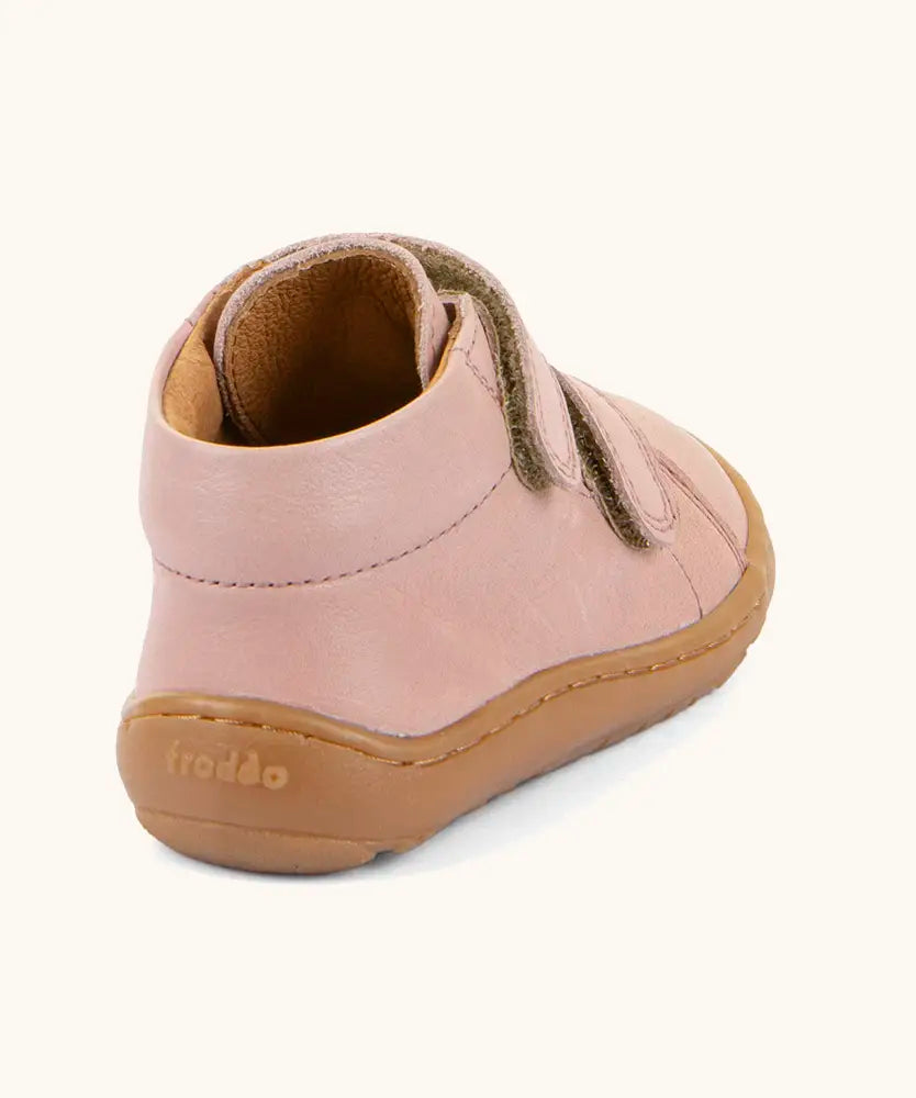 Back of the Froddo barefoot first step baby shoe in pale pink showing a padded ankle support and grippy sole 