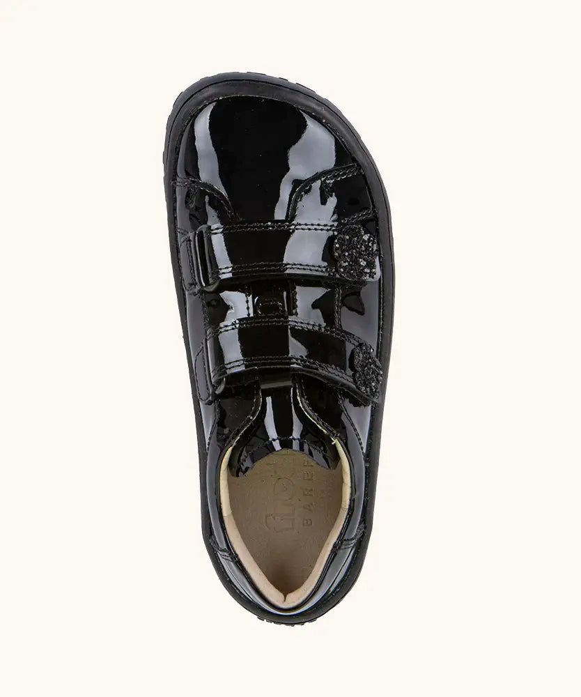 Top view of the Froddo Alexandra barefoot kids school shoe in black patent. A low profile shoe with 2 front velcro straps