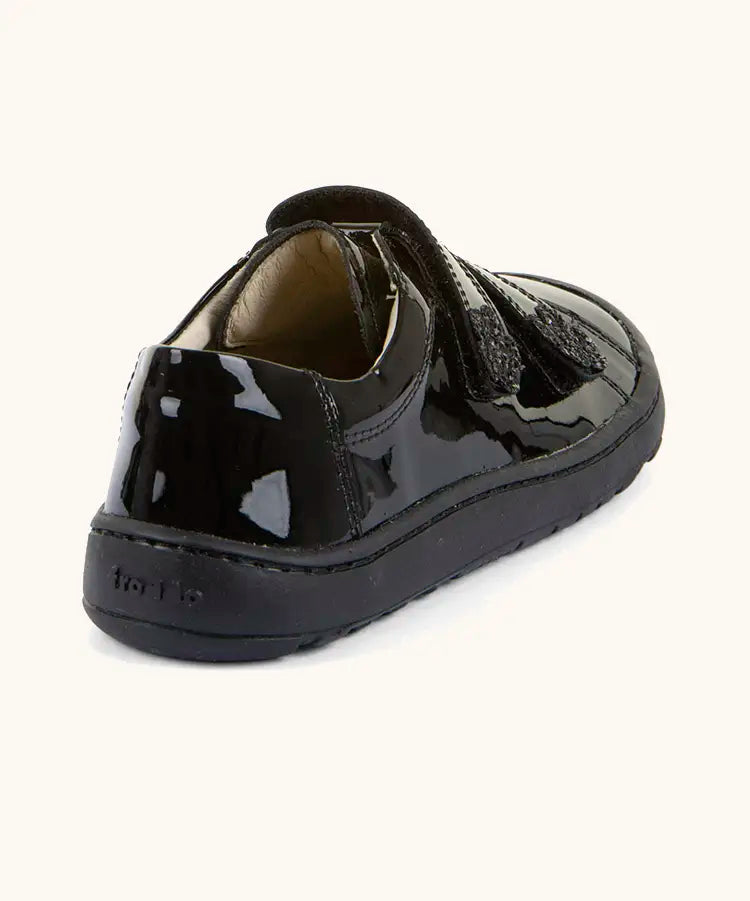 Back of Froddo barefoot kids school shoe in black patent. A low profile shoe with a padded ankle support and rubber sole