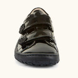 Front of Froddo barefoot kids school shoe in black patent. A low profile shoe showing 2 velcro straps with a decoration on the end