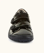 Front of Froddo barefoot kids school shoe in black patent. A low profile shoe showing 2 velcro straps with a decoration on the end