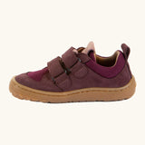 Side of Froddo's maroon barefoot baze kids shoes showing the velcro straps looped through the eyelets. Trainer has a zero heel drop design 