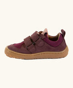 Side of Froddo's maroon barefoot baze kids shoes showing the velcro straps looped through the eyelets. Trainer has a zero heel drop design 