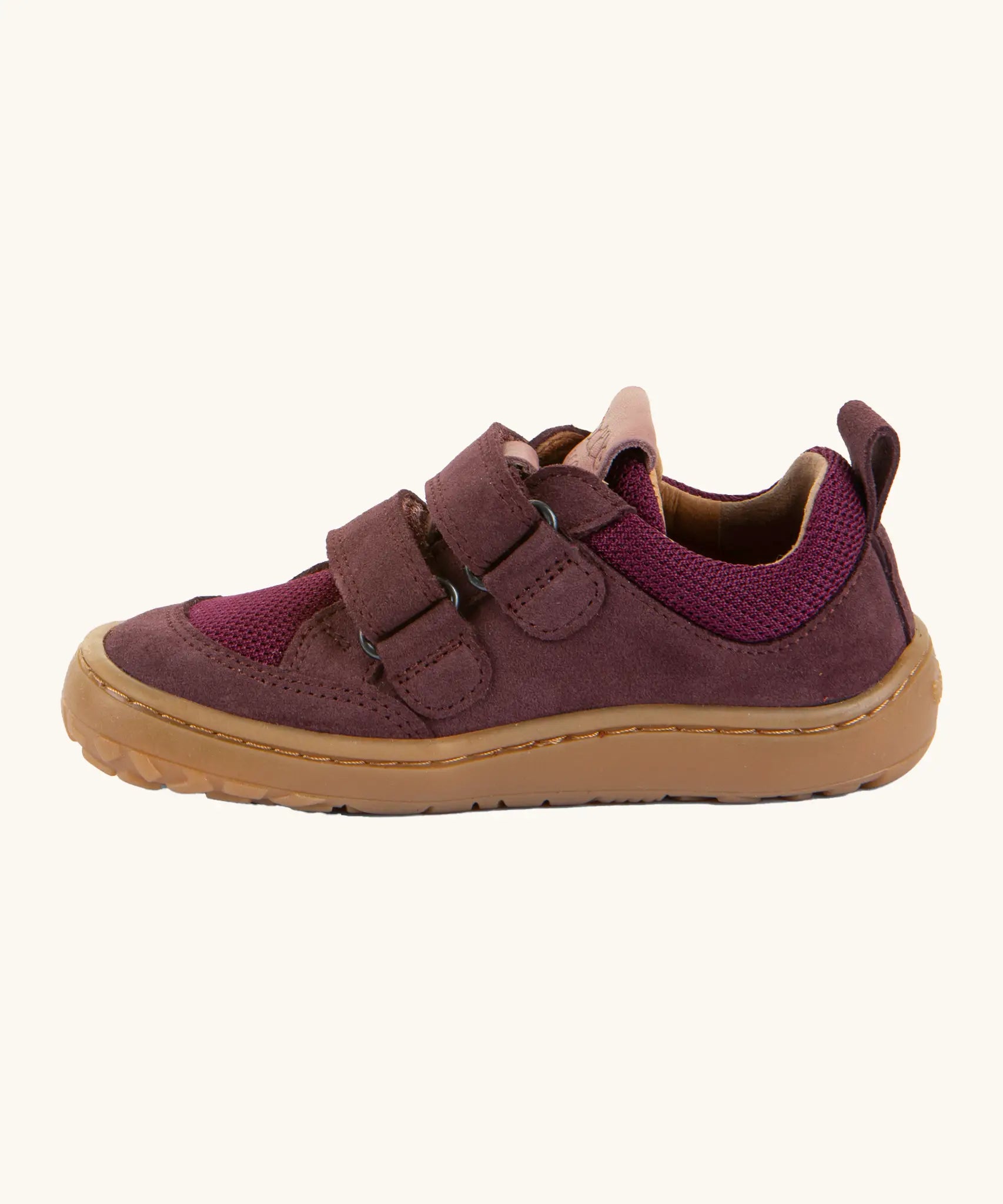 Side of Froddo's maroon barefoot baze kids shoes showing the velcro straps looped through the eyelets. Trainer has a zero heel drop design 