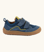 Side of Froddo's denim blue barefoot baze kids shoes. Features a brown rubber flexible sole. Trainer has a zero heel drop and wide, foot-shaped design.