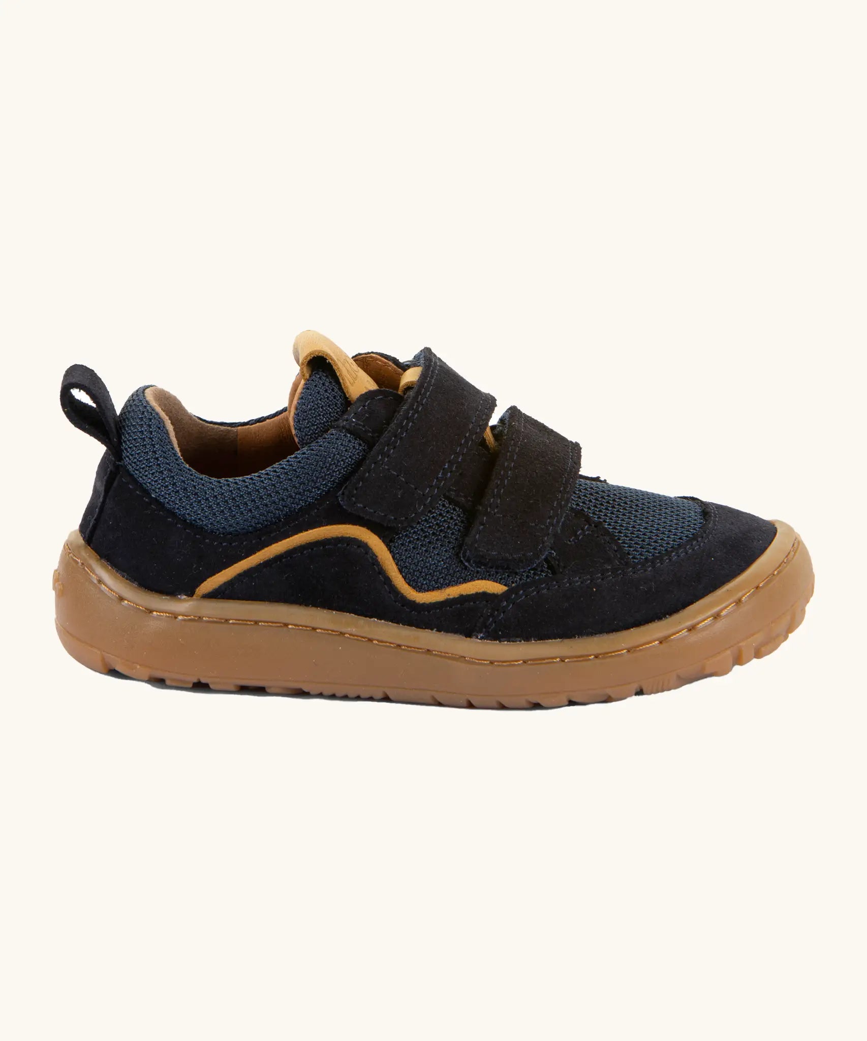Side of Froddo's navy blue barefoot baze kids shoes. Features a brown rubber flexible sole. Trainer has a zero heel drop and wide, foot-shaped design.