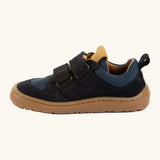 Side of Froddo's navy blue barefoot baze kids shoes showing the velcro straps looped through the eyelets. Trainer has a zero heel drop design 