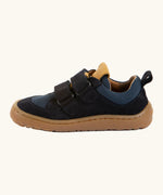 Side of Froddo's navy blue barefoot baze kids shoes showing the velcro straps looped through the eyelets. Trainer has a zero heel drop design 