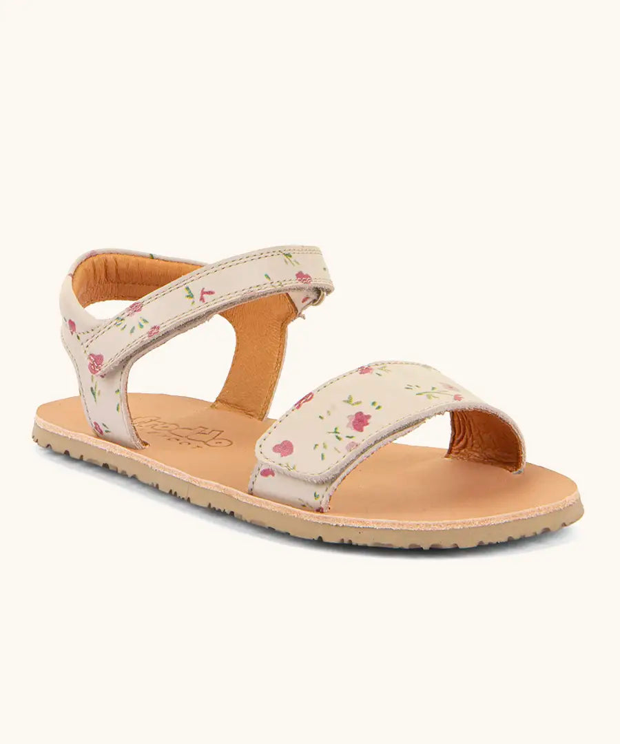 Froddo barefoot kids natural leather sandal in pink with flowers. Showing a velcro strap and buckle fastener on the front