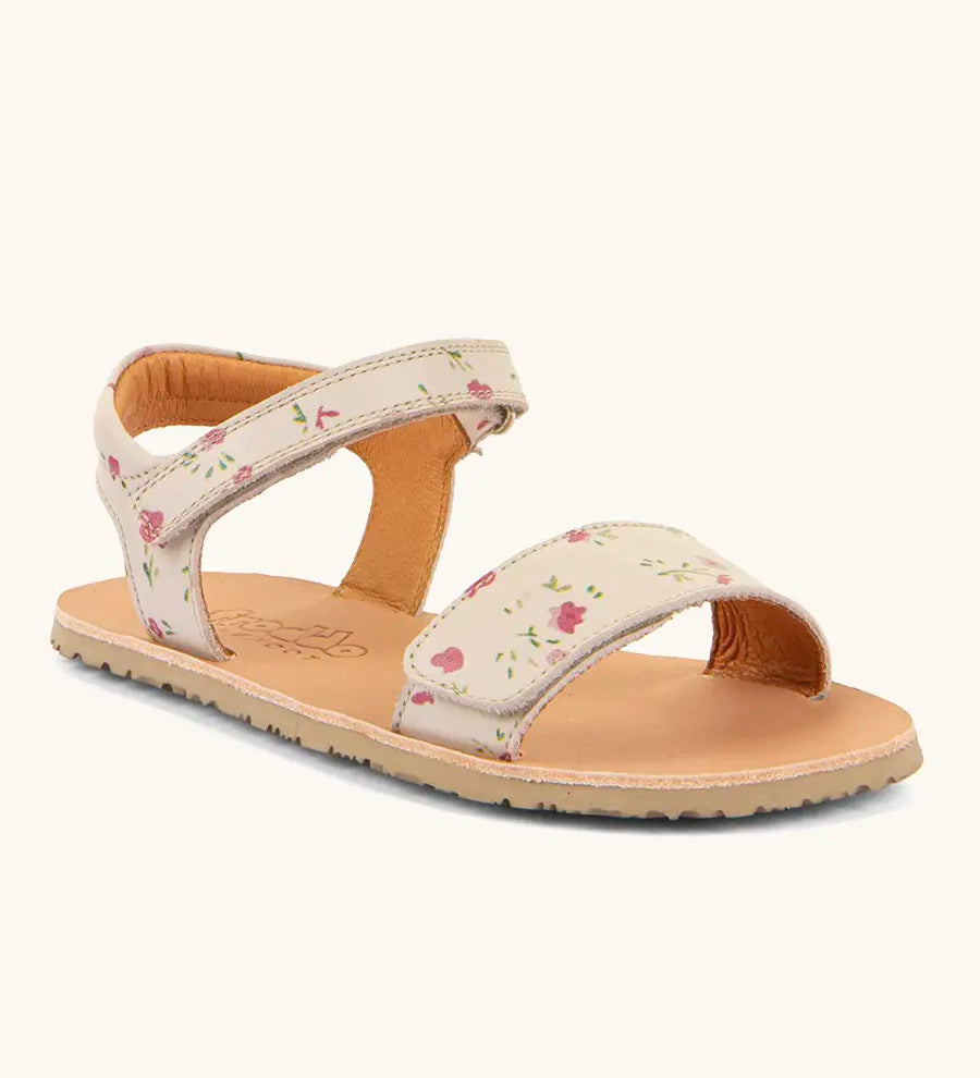 Froddo barefoot kids natural leather sandal in pink with flowers. Showing a velcro strap and buckle fastener on the front