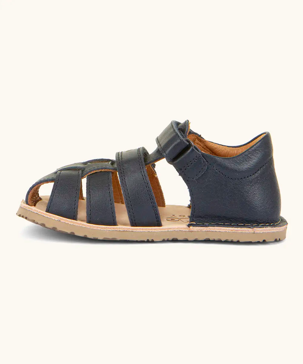 Froddo barefoot natural leather kids flexy sandal in dark blue showing a velcro strap looped through eyelet