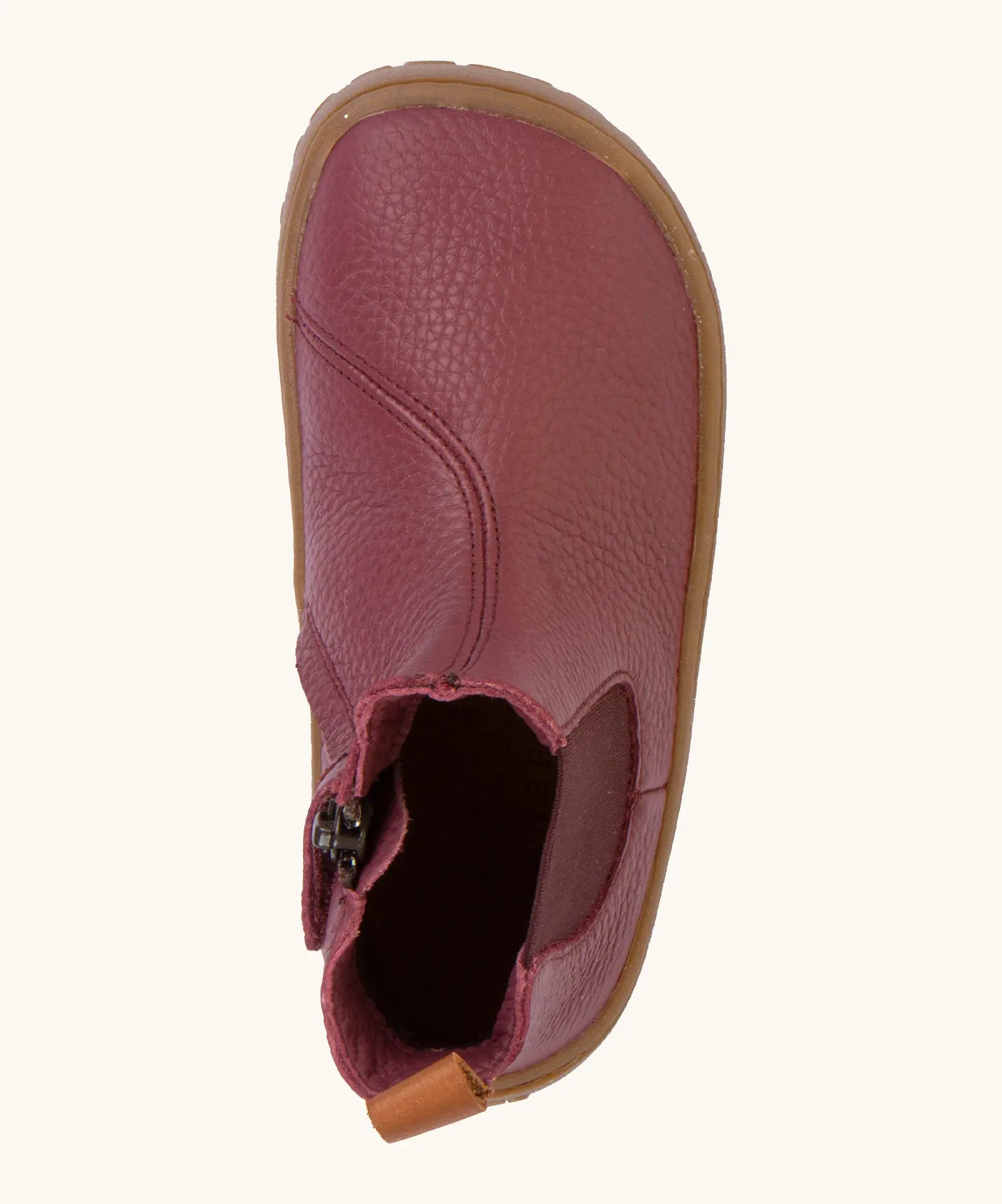 A top view of the Froddo barefoot kids leather chelsea boots in Bordeaux maroon showing the pull tab and insole detail