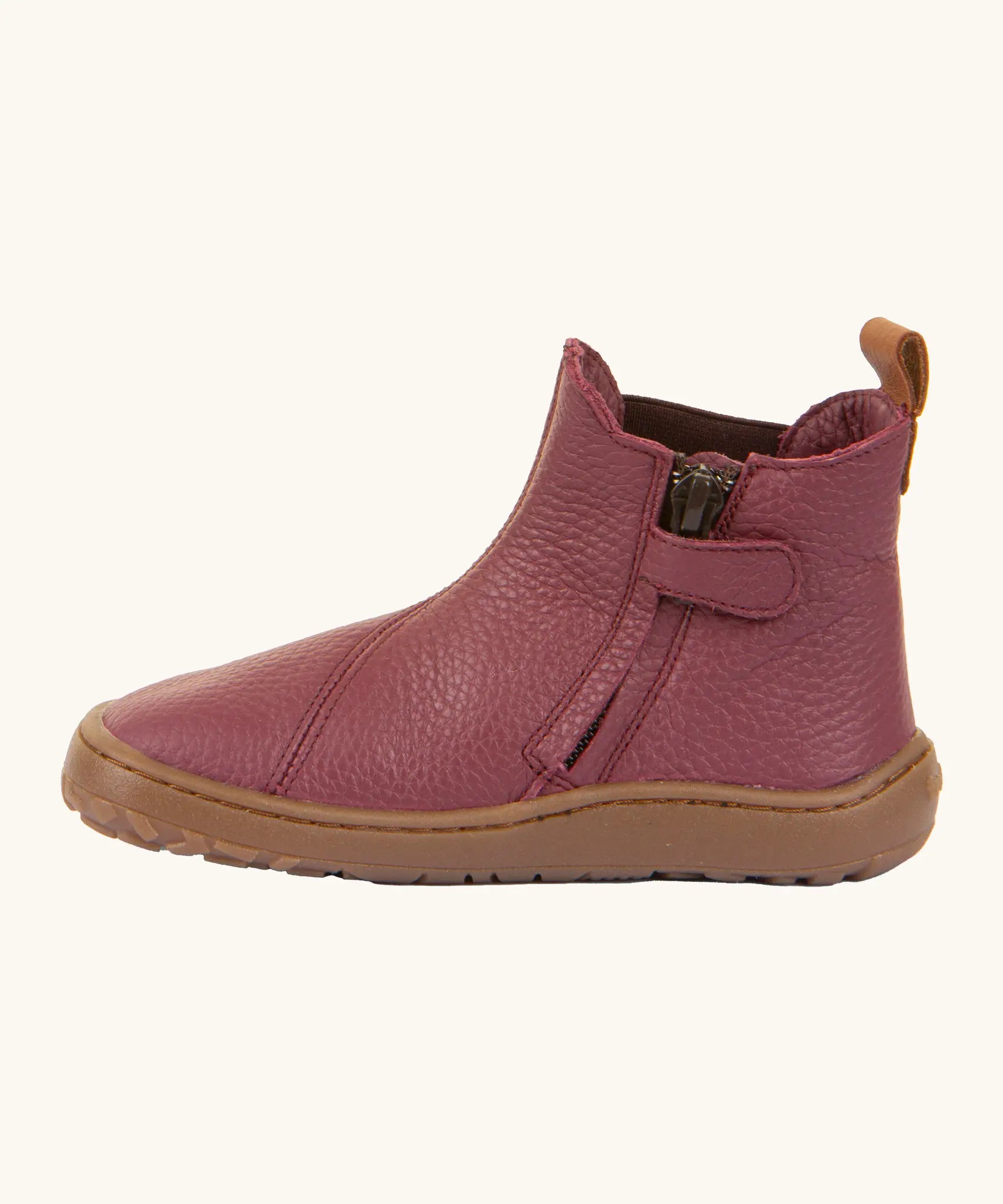 Side of the Froddo barefoot kids leather chelsea boots in Bordeaux maroon showing the zip fastener detail running down the boot 