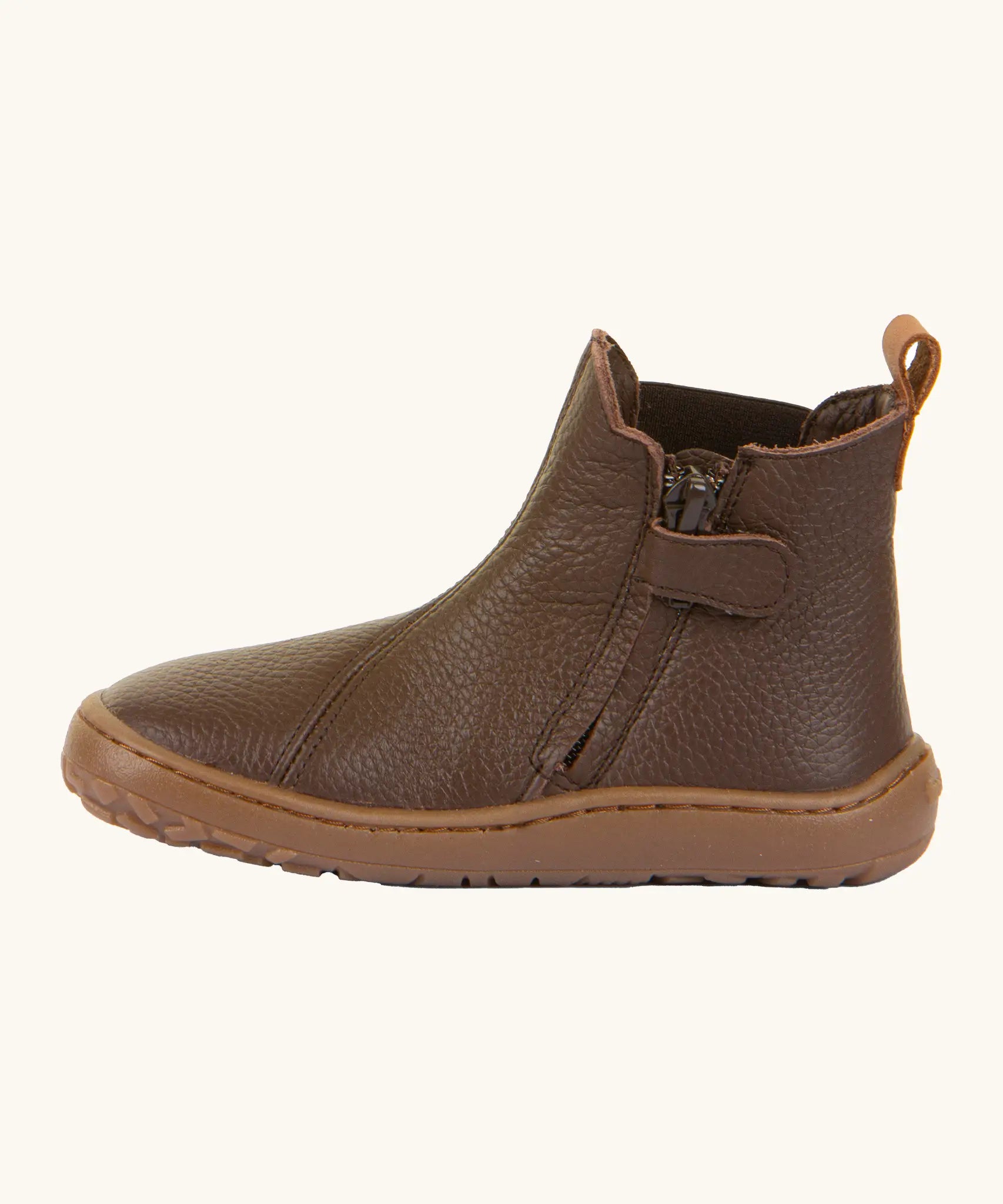 Side of the Froddo barefoot kids leather chelsea boots in brown showing the zip fastener detail running down the boot 