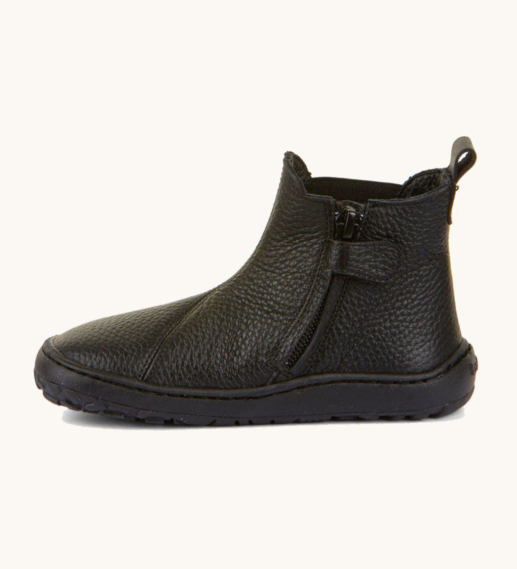 A side image of the Froddo barefoot kids leather school chelsea boots available at Babipur showing the zip fastener detail running down the boot 