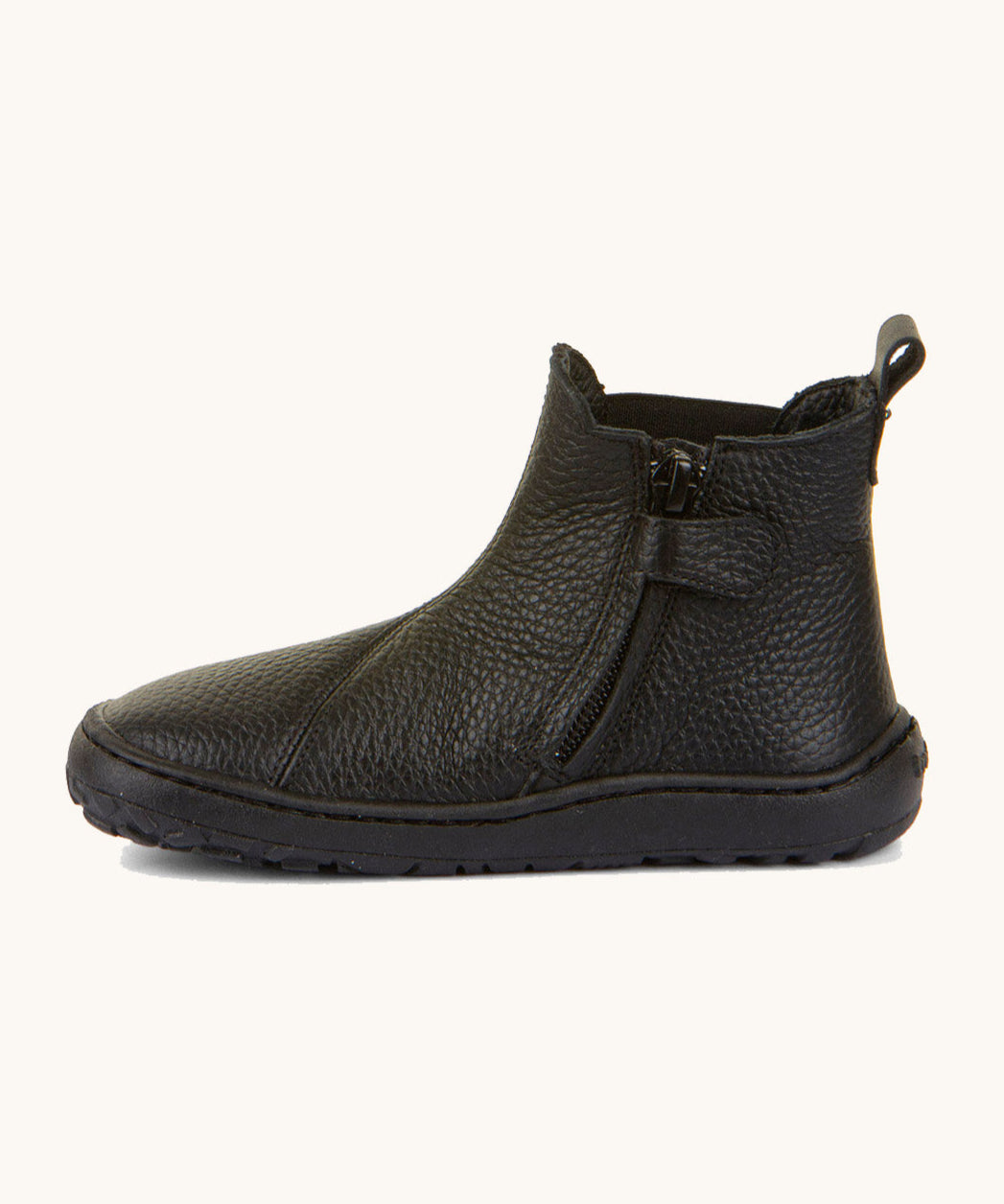 A side image of the Froddo barefoot kids leather school chelsea boots available at Babipur showing the zip fastener detail running down the boot 