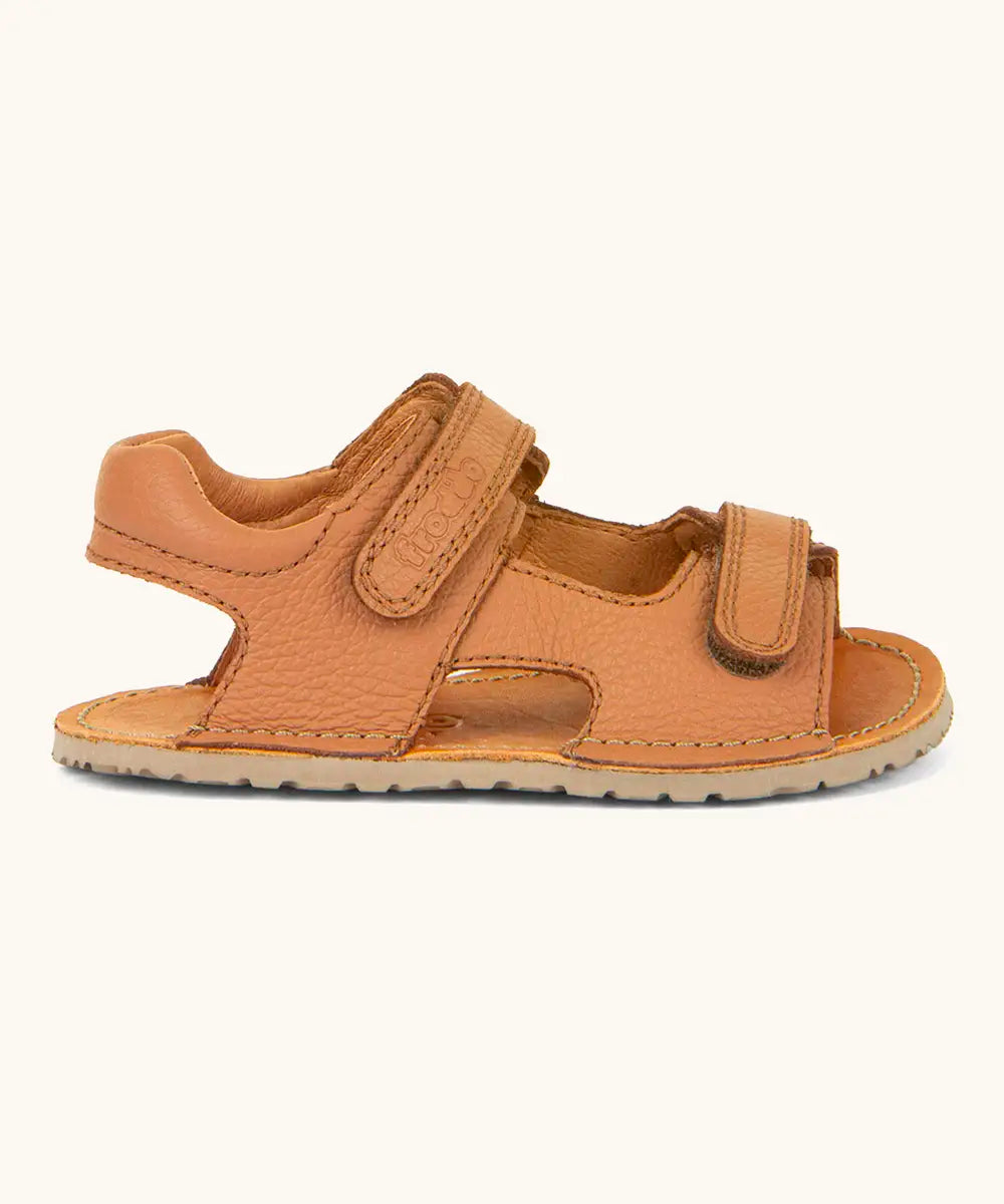 Froddo barefoot kids natural leather sandal in dark blue showing the padded ankle support and rubber sole