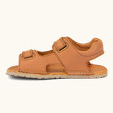 Side of Froddo barefoot kids natural leather sandal in tan brown showing velcro straps looped through the eyelets