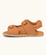 Side of Froddo barefoot kids natural leather sandal in tan brown showing velcro straps looped through the eyelets
