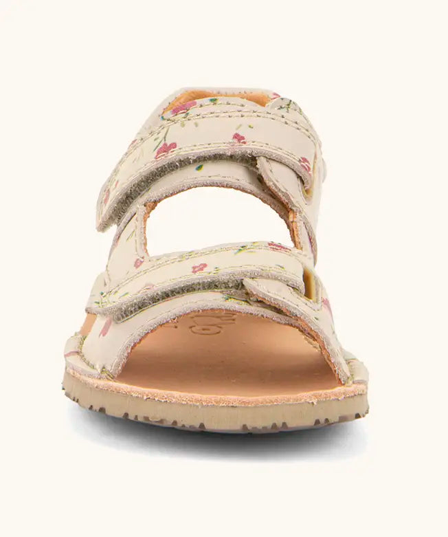 Front of Froddo barefoot kids natural leather sandal in pink with flowers showing 2 front velcro straps and rubber sole