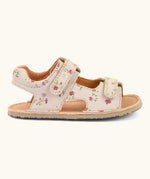 Side of Froddo barefoot kids natural leather sandal in pink with flowers showing the padded ankle support and rubber sole