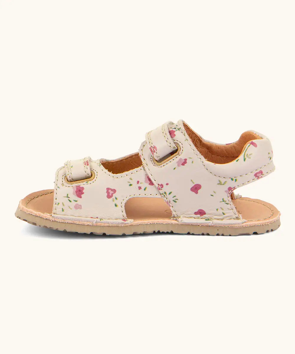 Froddo barefoot kids natural leather sandal in pink with flowers showing the velcro fasteners looped through the eyelets