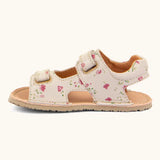 Froddo barefoot kids natural leather sandal in pink with flowers showing the velcro fasteners looped through the eyelets