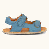 Side of Froddo barefoot kids natural leather sandal in light blue showing velcro straps, padded ankle support and rubber sole