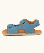 Side of Froddo barefoot kids natural leather sandal in light blue showing velcro straps looped through the eyelets