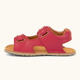 Side of Froddo barefoot kids natural leather sandal in red showing velcro straps looped through the eyelets