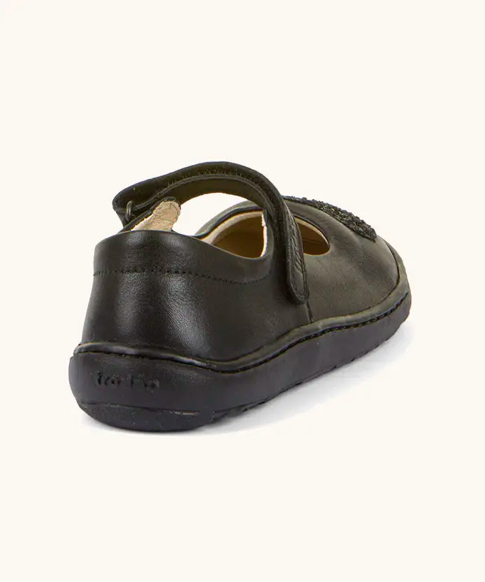 Back of Froddo barefoot kids natural black leather school shoe. A dolly shoe with a small padded ankle support