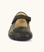 Front of Froddo barefoot kids natural black leather school shoe. A dolly shoe with a heart decoration on the front