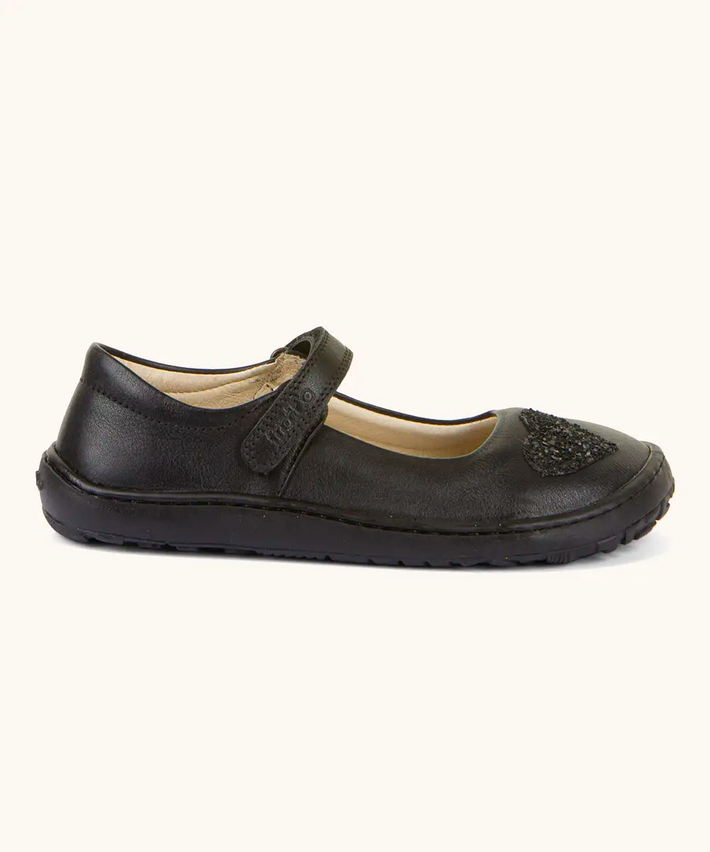 Side of Froddo barefoot kids natural leather school shoe showing the velcro strap