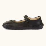 Side of Froddo barefoot kids natural black leather school shoe showing velcro strap looped through the eyelet