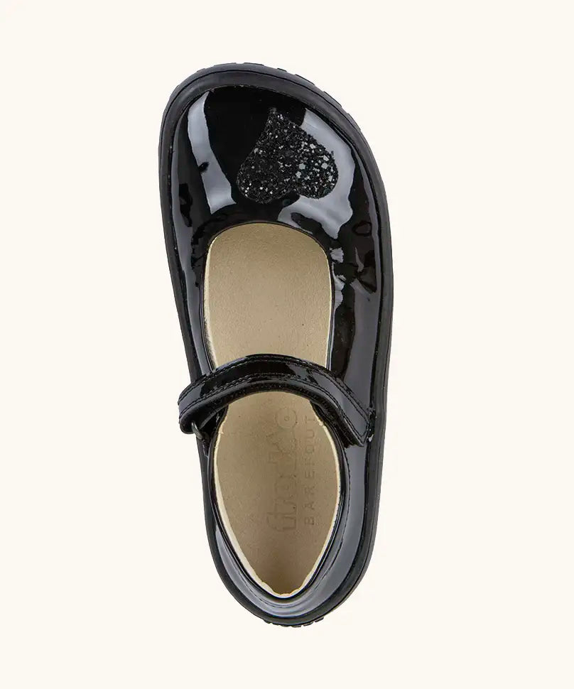 Top view of the Froddo barefoot kids black patent school shoe. A dolly shoe with a velcro fastener and heart decoration on the front