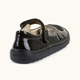 Back of Froddo barefoot kids black patent school shoe. A dolly shoe with a small padded ankle support
