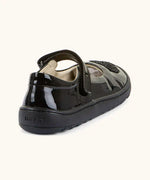 Back of Froddo barefoot kids black patent school shoe. A dolly shoe with a small padded ankle support