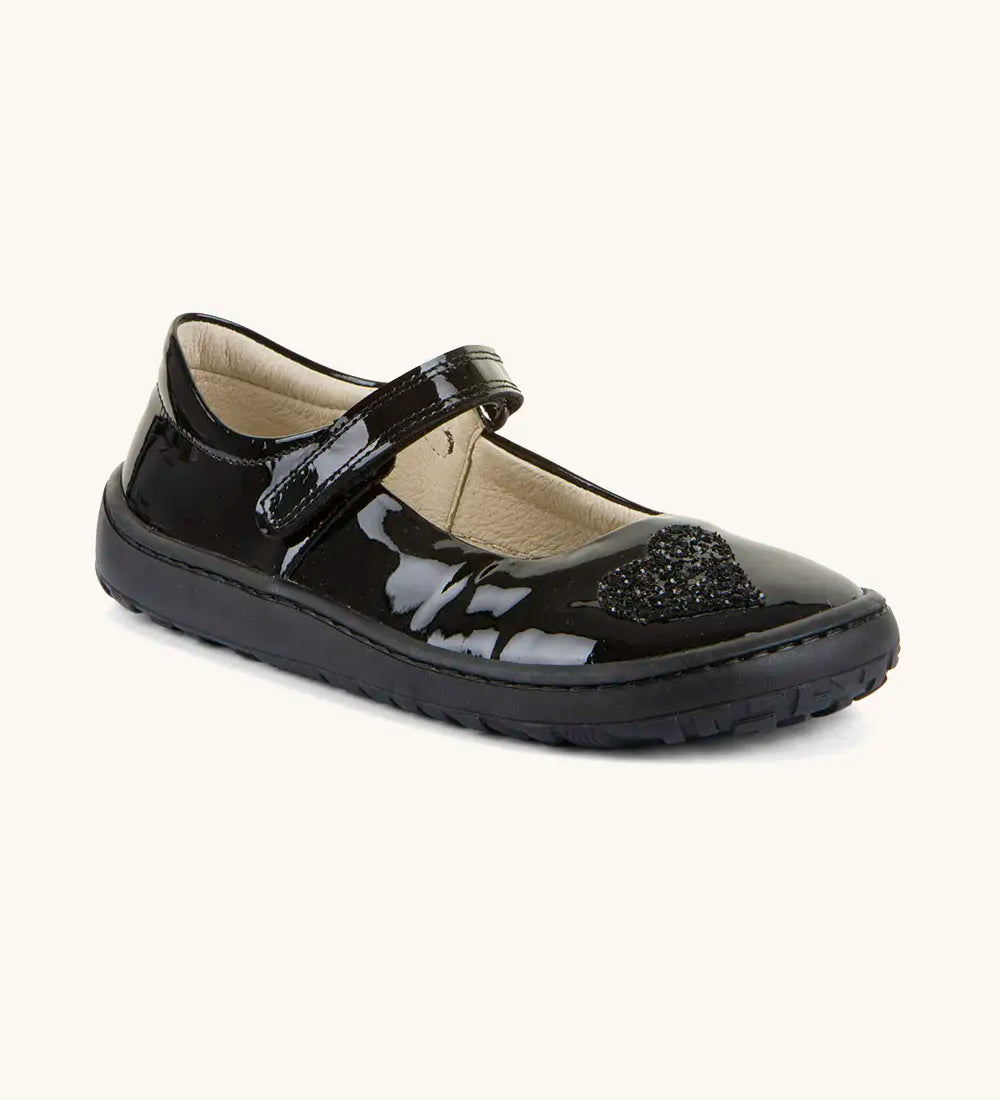 Froddo barefoot kids in black patent school shoe. A dolly shoe with a velcro fastener and heart decoration on the front