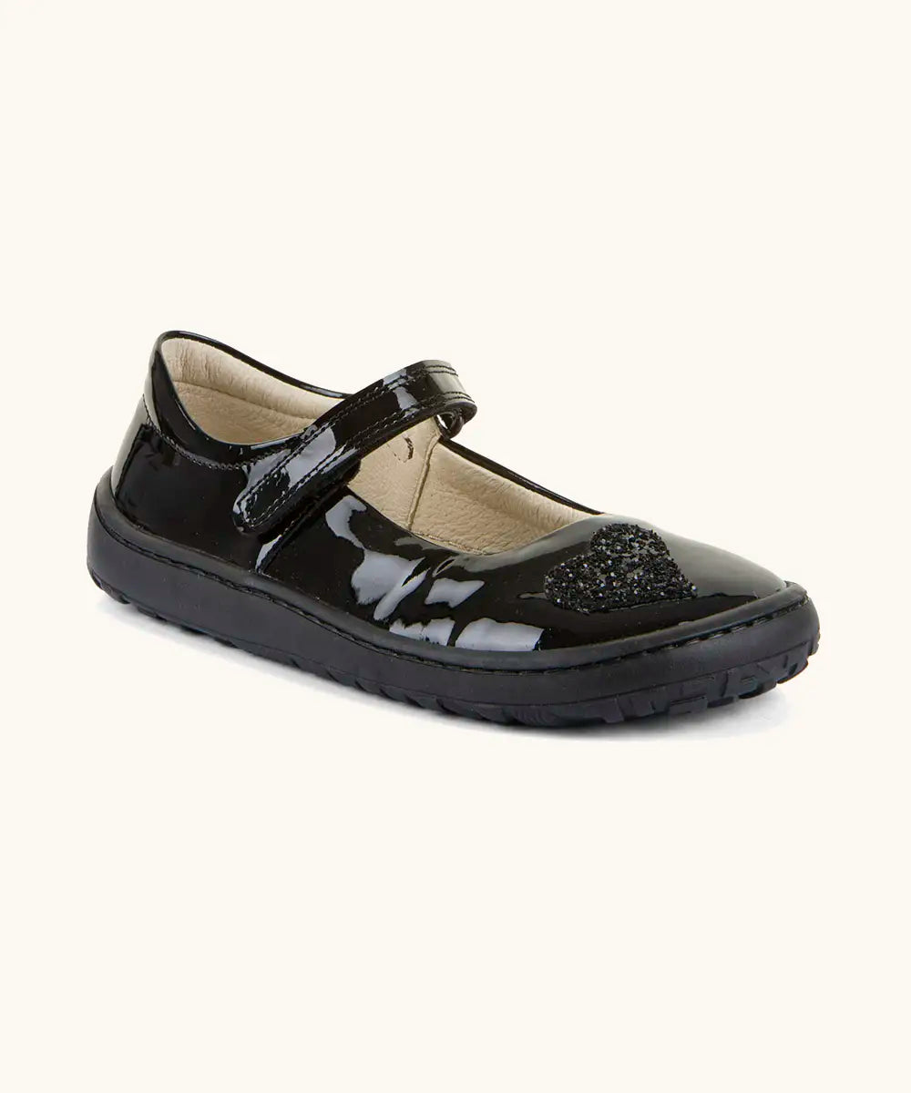 Froddo barefoot kids in black patent school shoe. A dolly shoe with a velcro fastener and heart decoration on the front