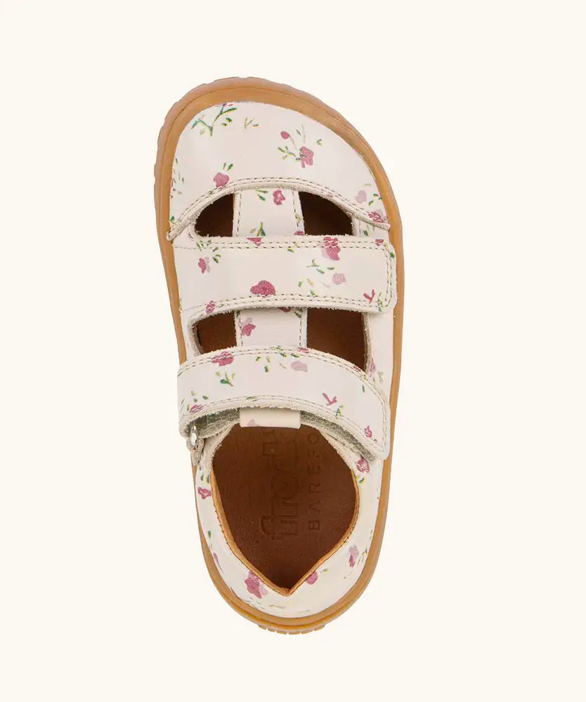Top view of Froddo barefoot children's sandal in pale pink with flowers showing the 2 velcro strap fastener and insole detail