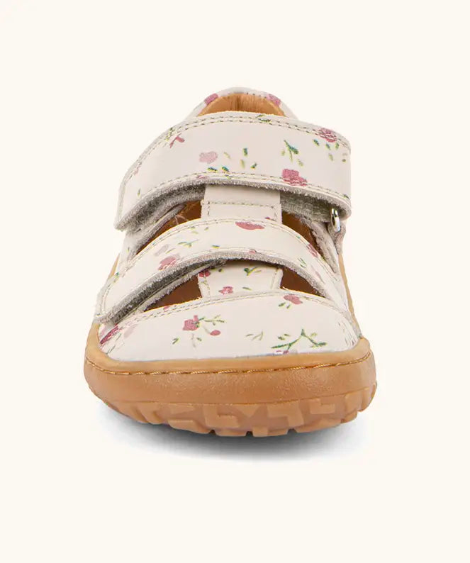 Front of the Froddo barefoot children's sandal in pink with flowers showing 2 velcro fasteners and a brown grippy sole