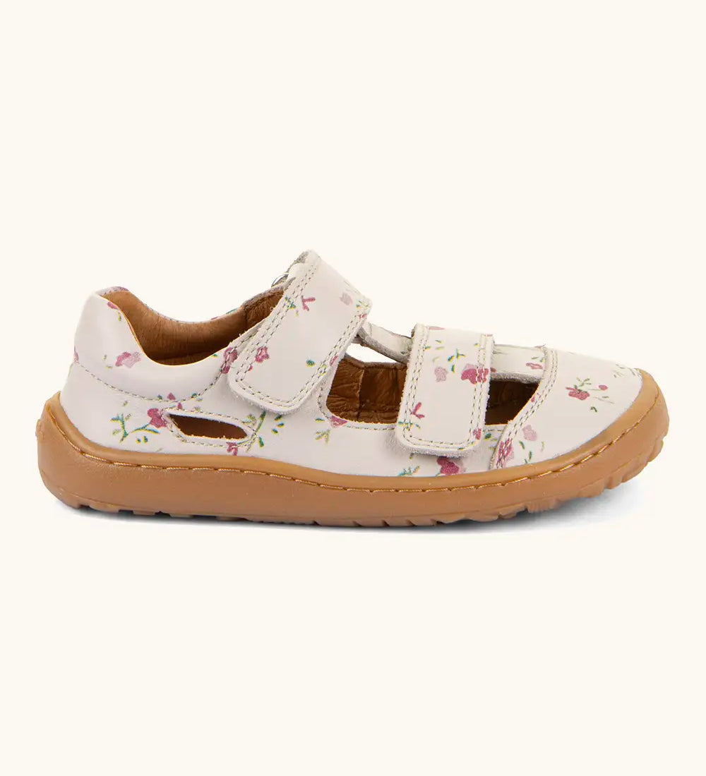 Froddo barefoot natural leather kids sandal in pale pink with flowers showing 2 velcro fasteners and a grippy sole