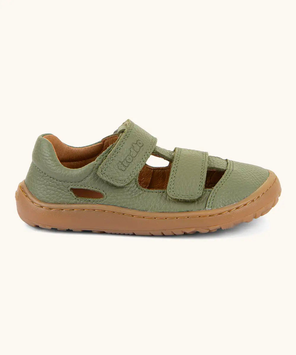 Froddo barefoot children's sandal in green. A natural leather low profile shoe showing 2 velcro fasteners and a rubber  sole
